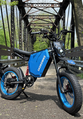 Couple riding SASIKEIBIKE electric bikes on a scenic road