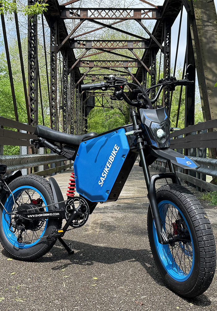 Couple riding SASIKEIBIKE electric bikes on a scenic road